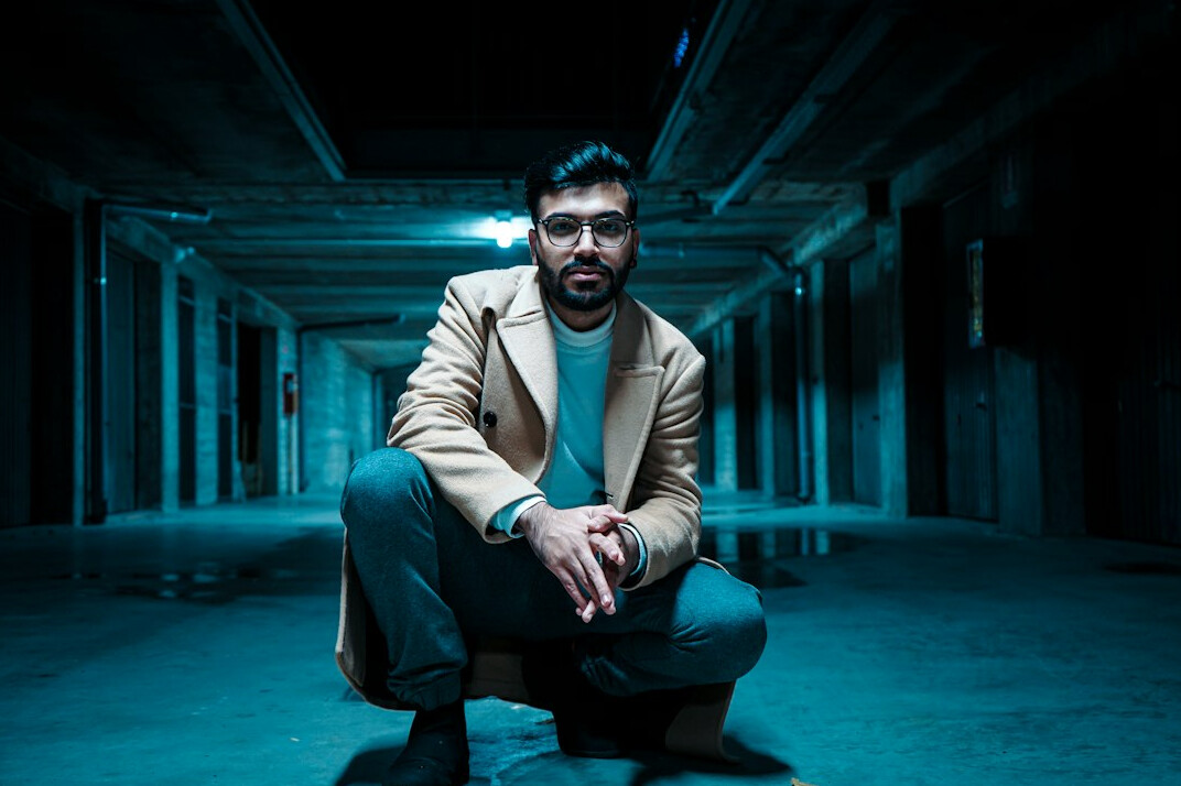 Professional portrait of a bearded man investigative editor