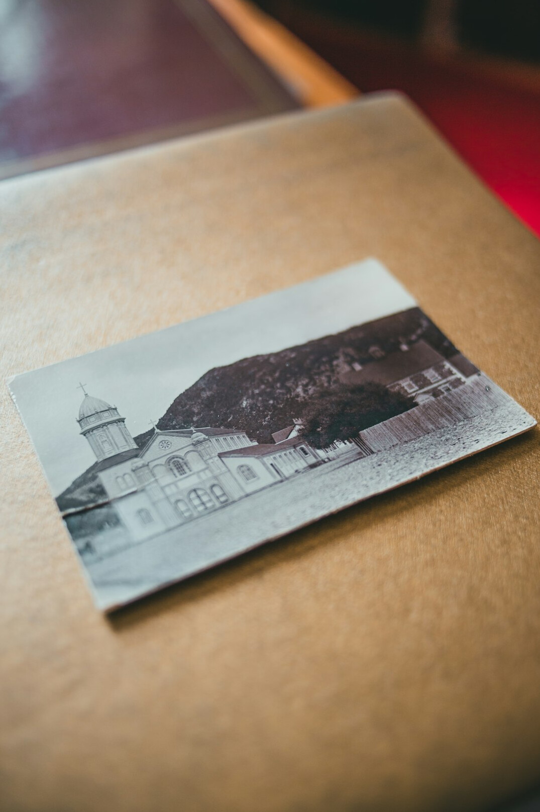 Folder with vintage maps photographs and documents on a table
