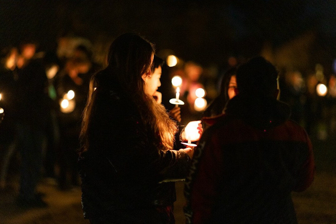 family holding vigil candles